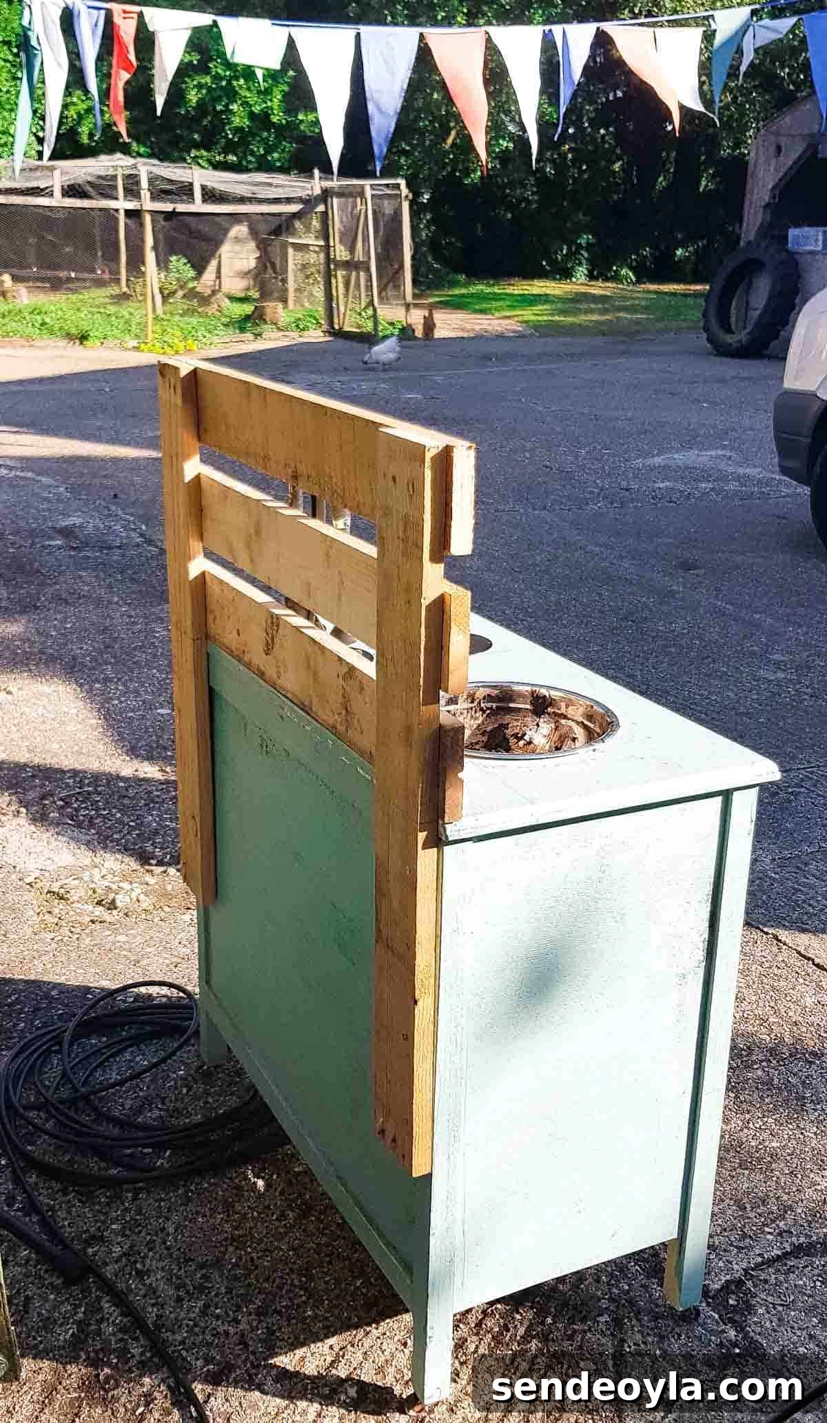 DIY pallet back on a repurposed set of old drawers which can be found on eBay to upcycle into a mud play kitchen.