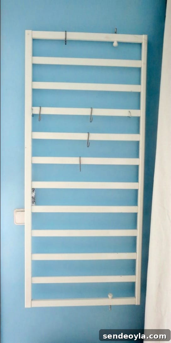Hanging the crib side on the wall to create an organizer