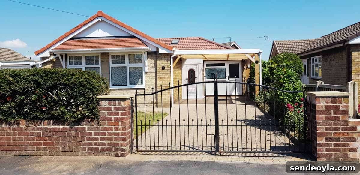 Double driveway gates installed at the front of a British bungalow house.