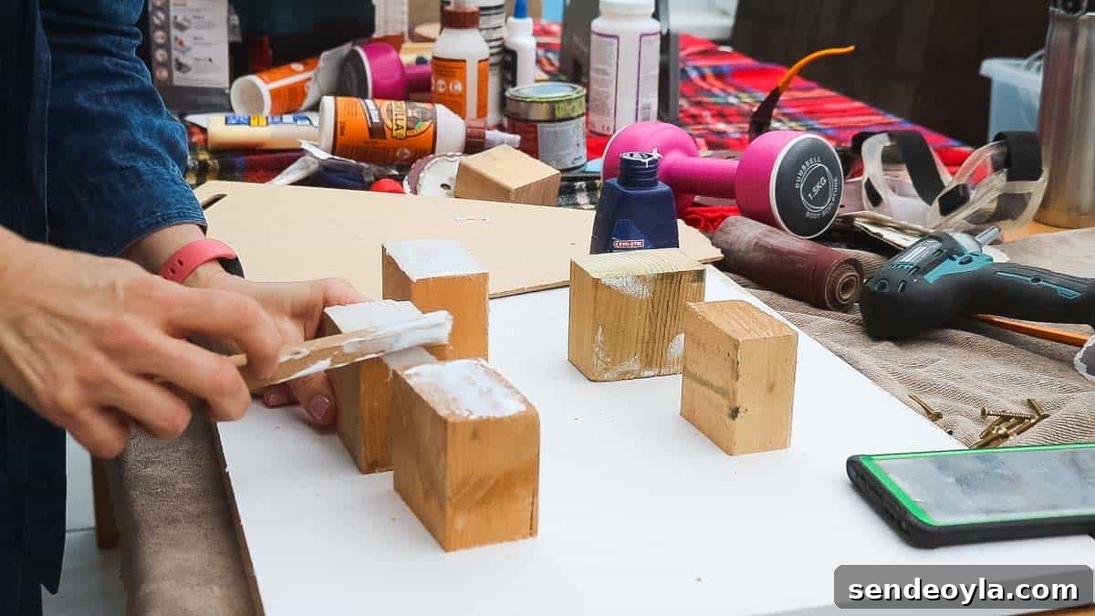 DIY Dumbbell Rack Tree Stand with Free Plans 11 Woman applying wood glue to small noggin blocks
