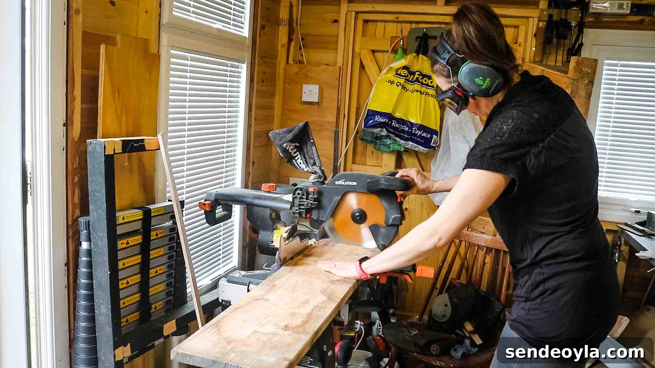 Female carpenters in a workshop using an Evolution mitre saw to cut shelves