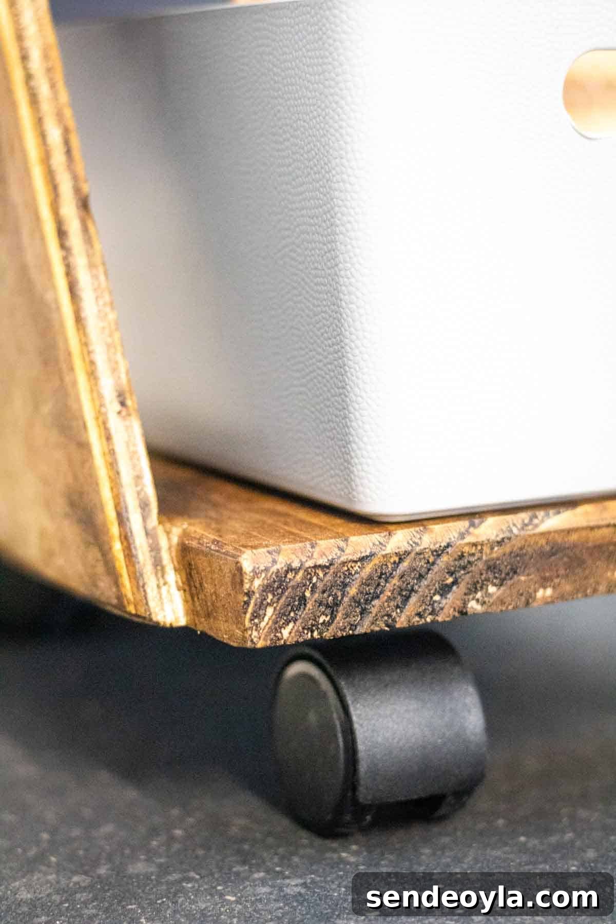 Close up of a castor wheel attached to a DIY Z shelf rolling trolley cart with Wham Studio grey plastic box