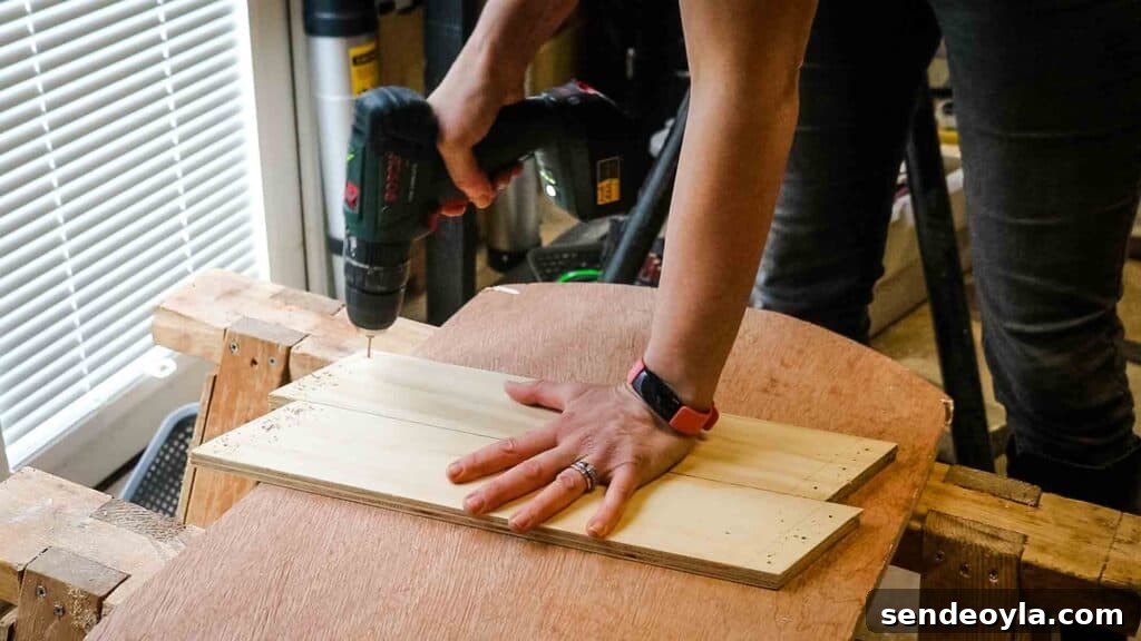 Woman drilling screw holes in plywood angled supports