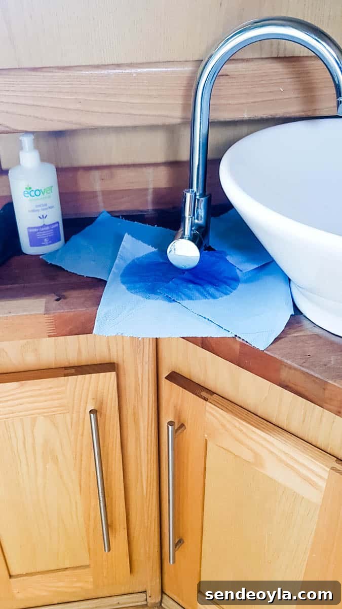 How to Replace a Mixer Tap on a Narrowboat or in Your Home 2 Tall tap leaking at the handle with kitchen paper underneath