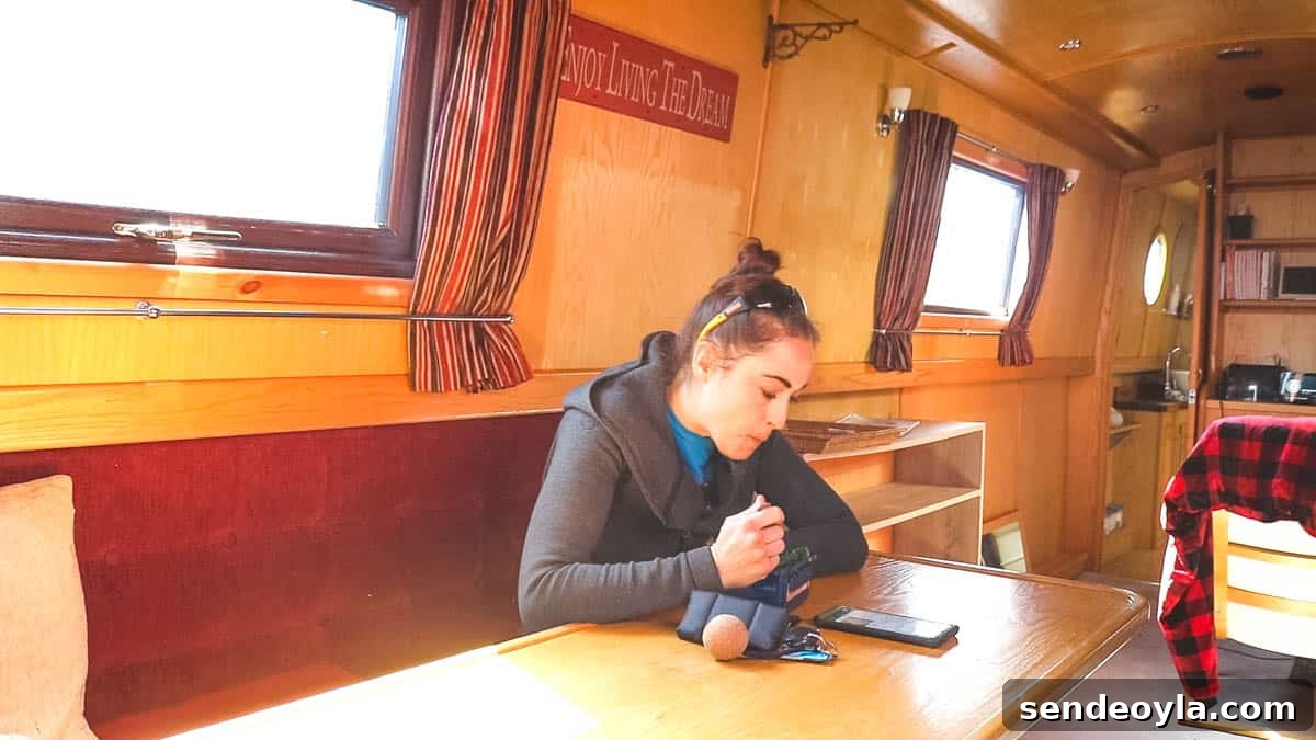 Inside a 57ft Reverse-Layout Narrowboat: Interior Tour 10 Woman eating at L-shaped dinette