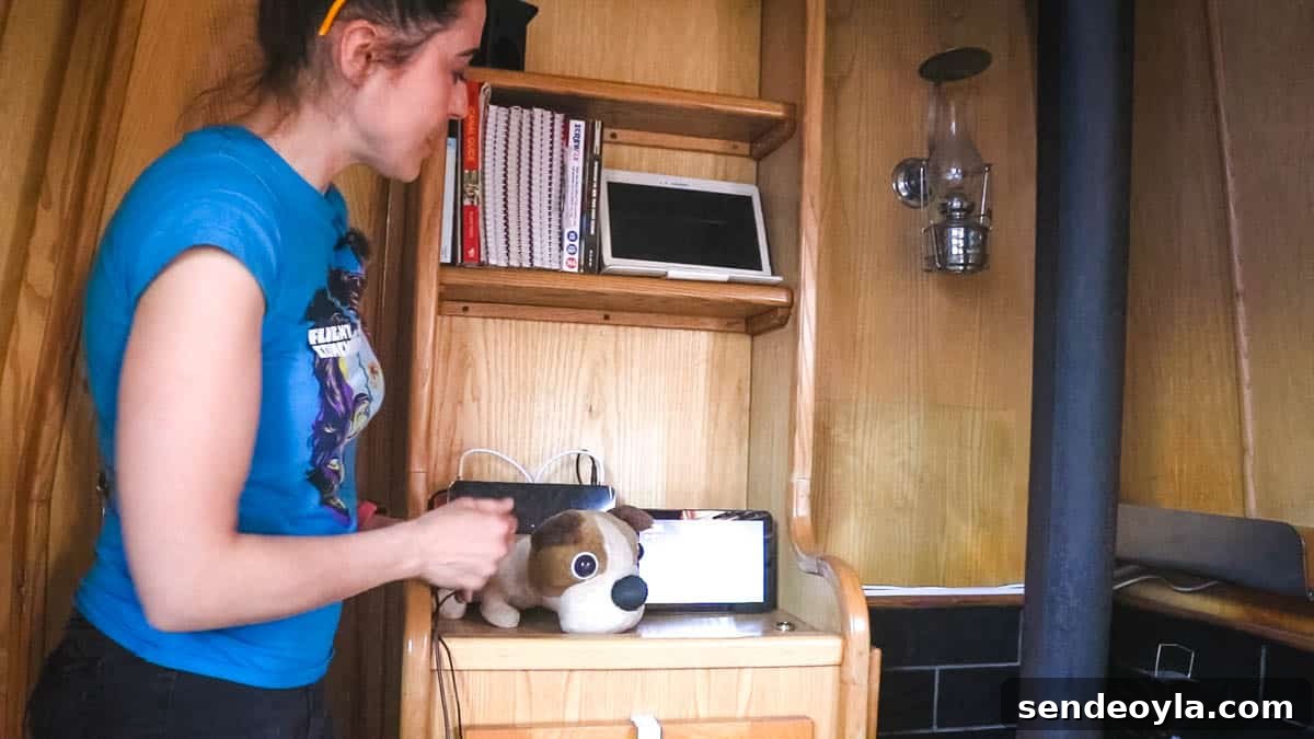 Inside a 57ft Reverse-Layout Narrowboat: Interior Tour 15 Woman stood front of internet and TV hub on boat