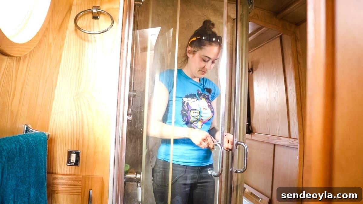 Inside a 57ft Reverse-Layout Narrowboat: Interior Tour 19 Woman stood fully clothed in narrowboat shower for size demonstration