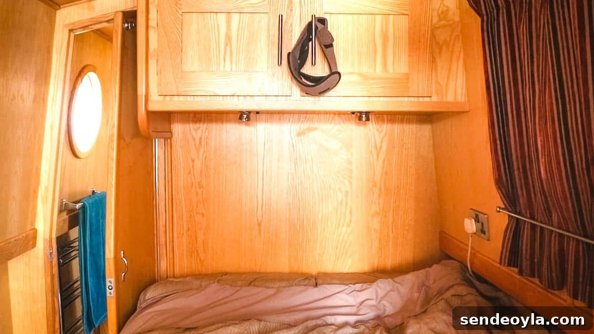 Inside a 57ft Reverse-Layout Narrowboat: Interior Tour 20 Overhead storage above small double bed on a boat