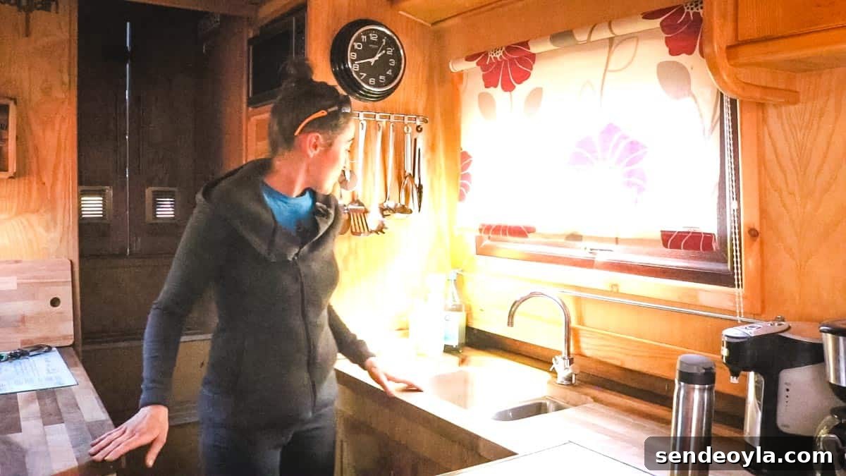 Inside a 57ft Reverse-Layout Narrowboat: Interior Tour 4 Woman standing in a reverse layout narrowboat kitchen