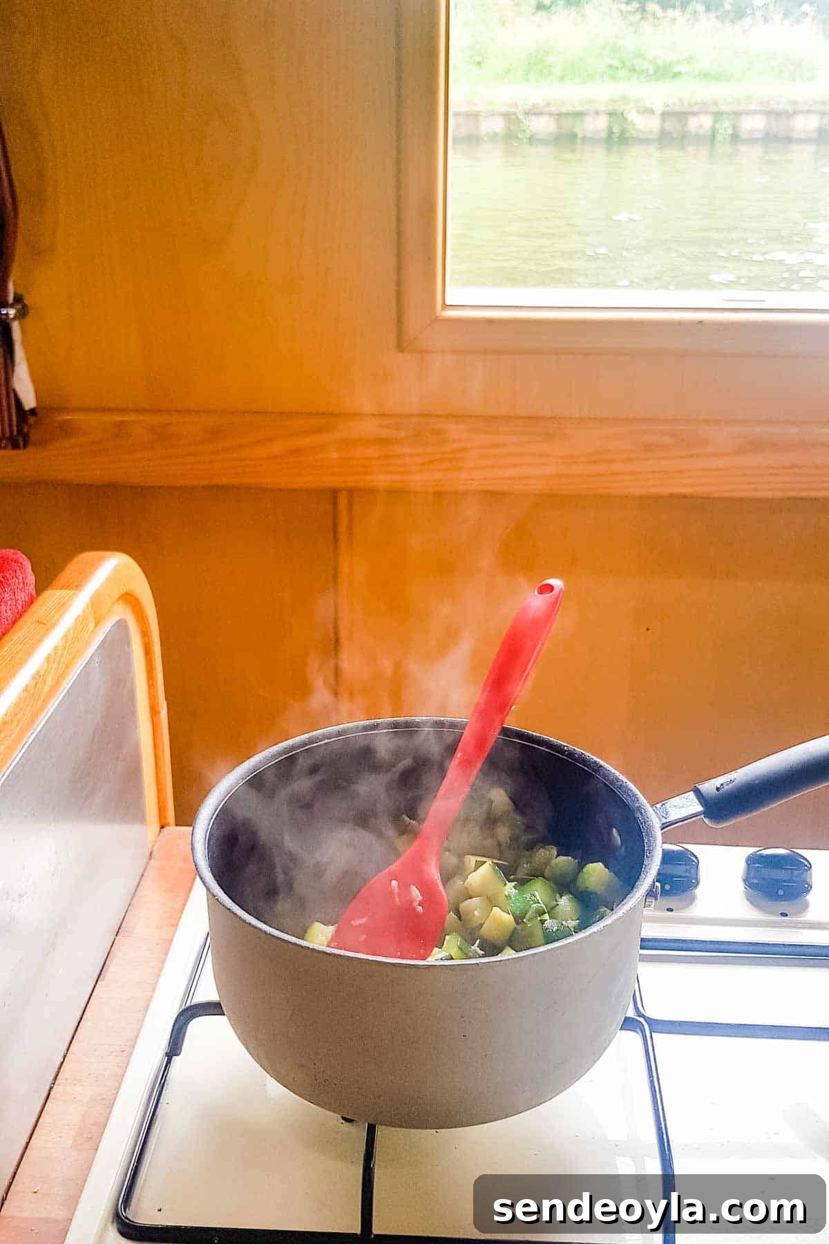 Chunky Keto Zucchini and Cheese Soup 3 Frying zucchini in an English narrowboat kitchen on the hob