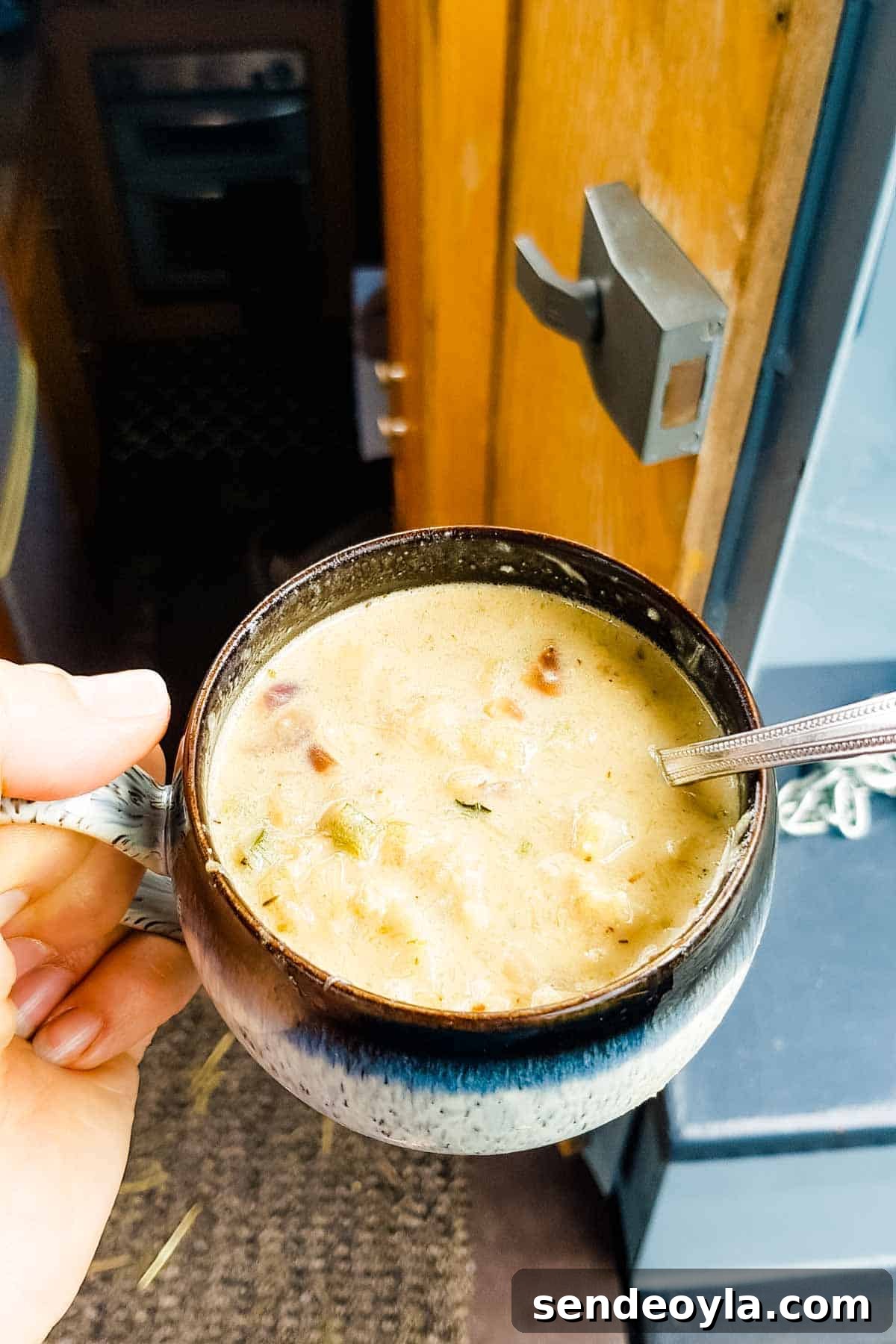 Close up of a keto cheesy and creamy soup in a Denby Halo range cup on the back of a narrowboat
