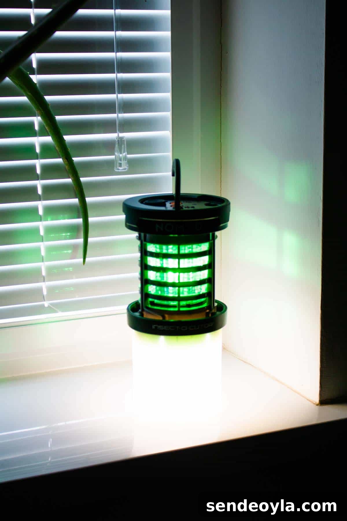 Insect-O-Cutor Nomad Fly Killer: Hands-On Review 2 Insect o Cutor on a windowsill with both the green light fly killer and lamp switched on