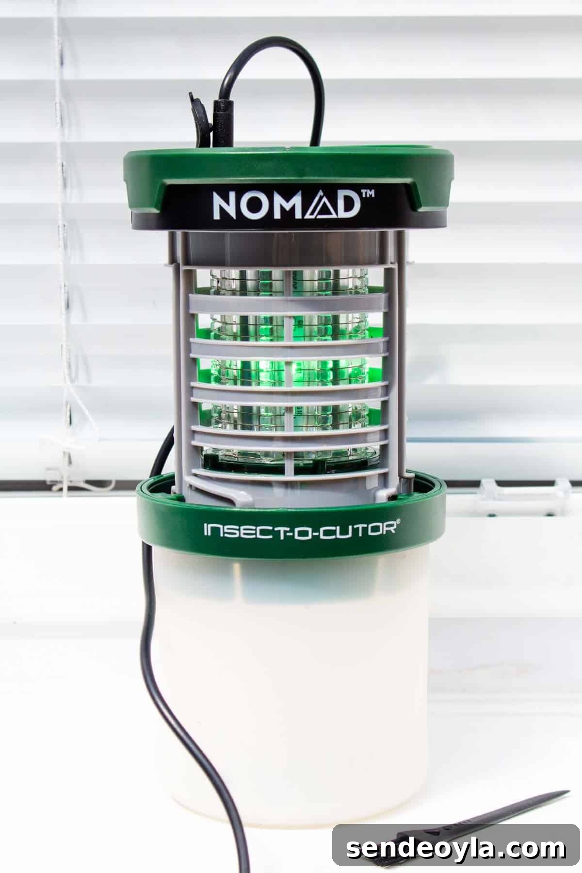Insect-O-Cutor Nomad Fly Killer: Hands-On Review 5 USB fly killer on a windowsill, charging with cable plugged in next to brush
