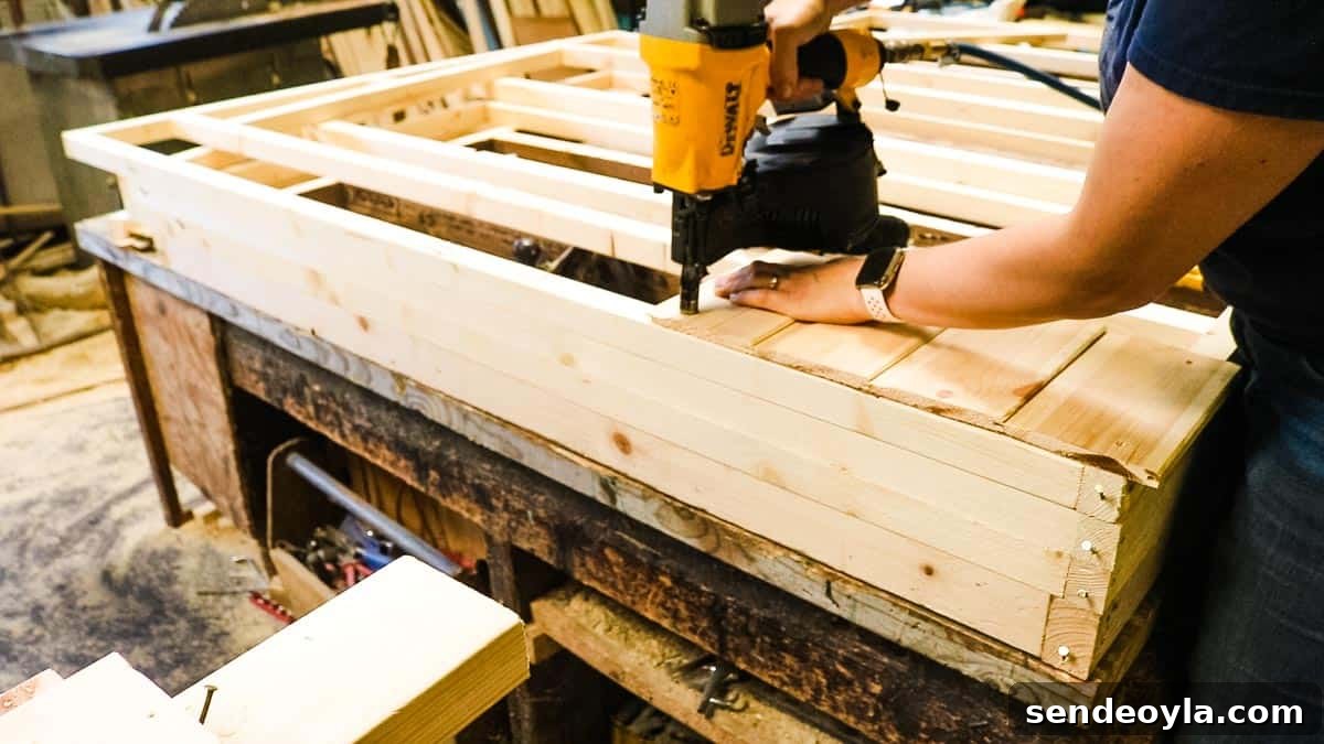 How to Build a Lean-To Shed with Free Plans 13 Nail gunning cladding to shed