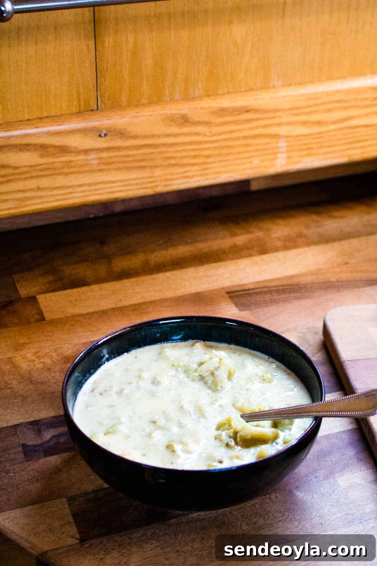 Chunky Keto Broccoli and Cheese Soup Recipe 4 Bowl of soup on a wooden butcher block kitchen worktop in a narrowboat