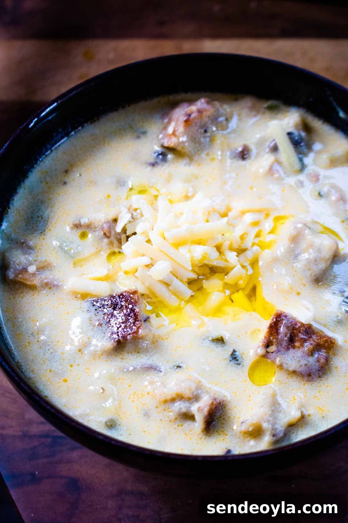 Hearty Cheesy Bacon and Chorizo Bread Soup Recipe 2 Denby Halo bowl full of creamy and chunky sourdough bread soup with bacon, chorizo and cheese.