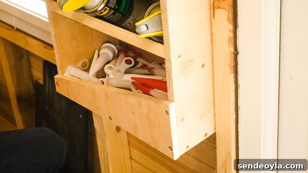 DIY Silicone Caulk Tube Organizer and Sealant Rack 11 Shelf at the bottom of a DIY silicone rack full of spouts