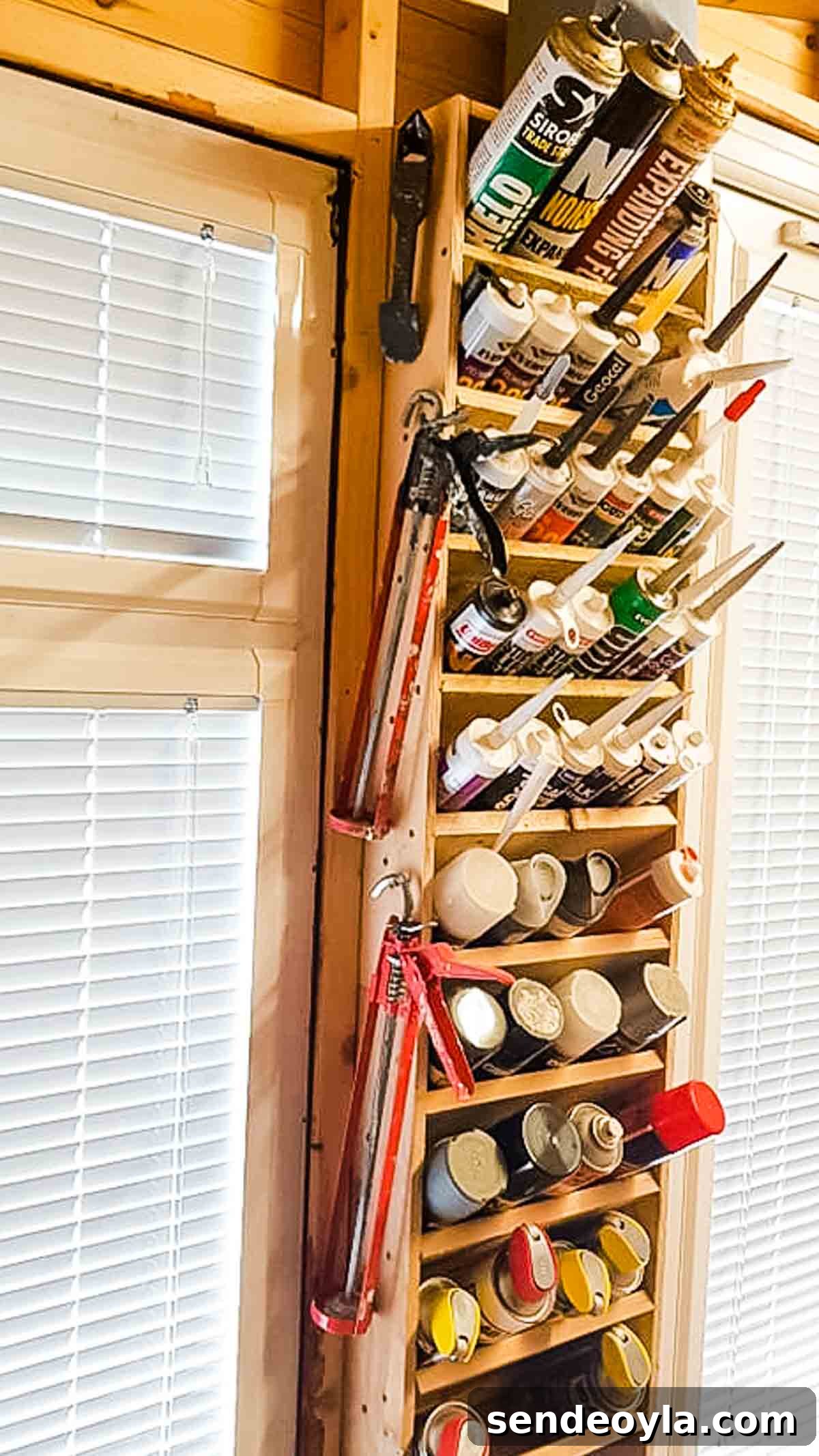 DIY Silicone Caulk Tube Organizer and Sealant Rack 3 Silicones in a wall mounted shelf with caulk guns hanging on the side