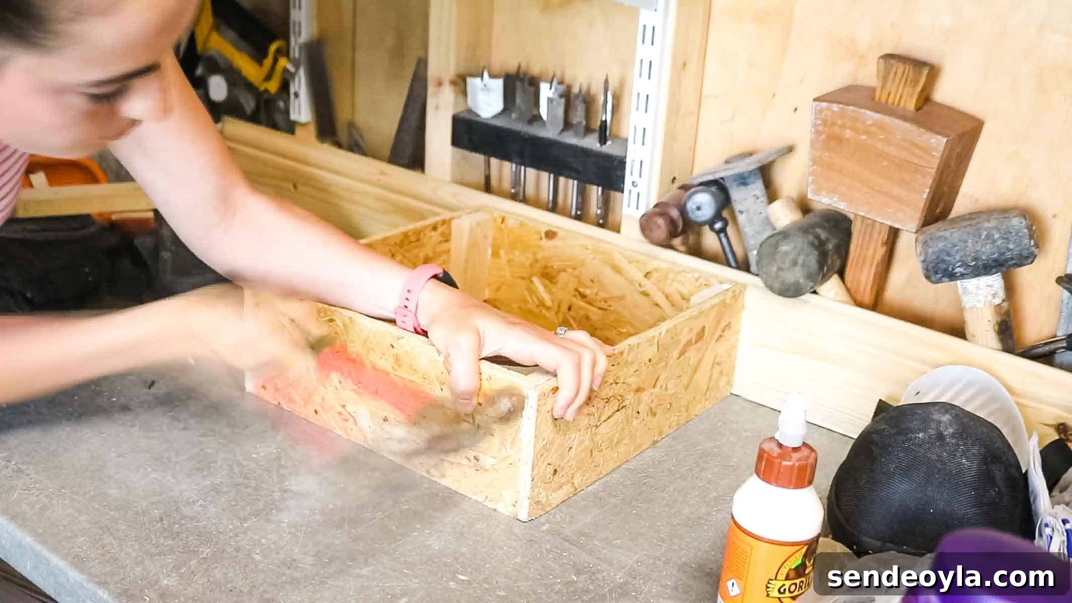 DIY Drawer Boxes for Workshop Storage: Step-by-Step Plans 5 Woman nailing OSB together where the corner supports meet