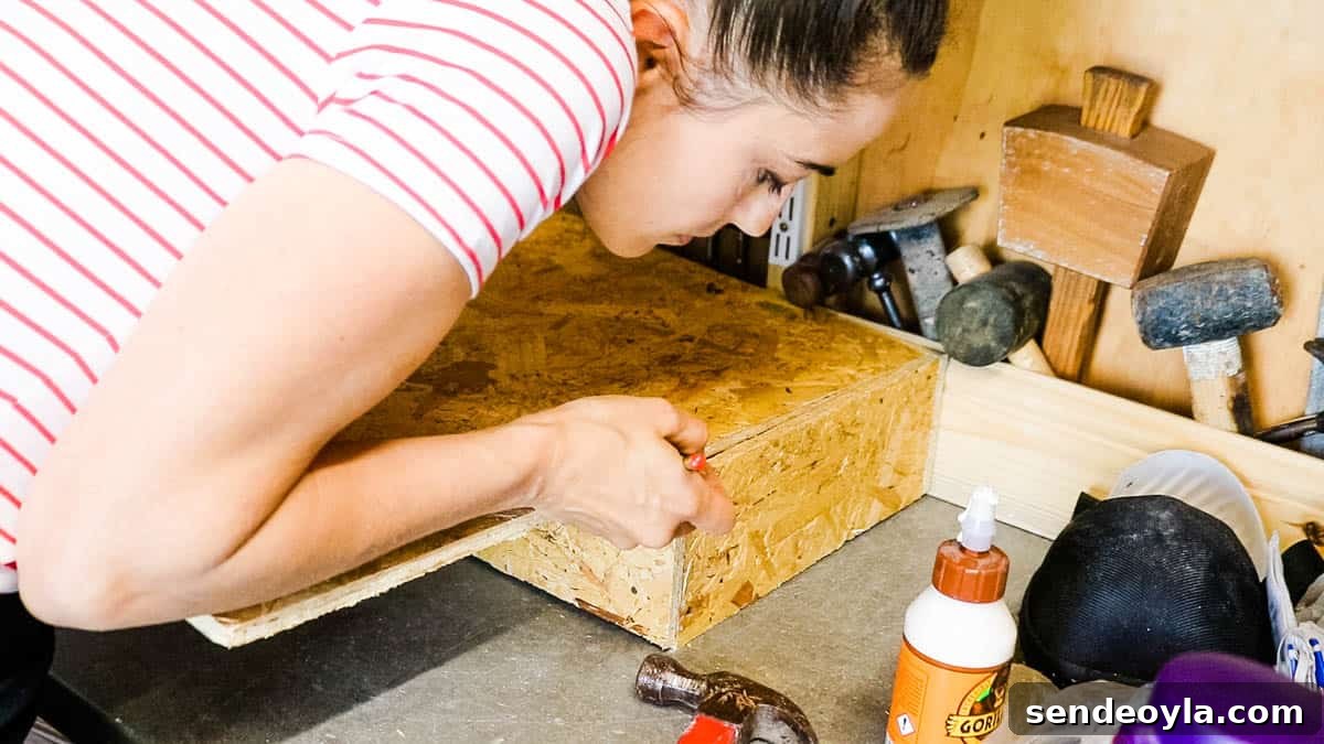 DIY Drawer Boxes for Workshop Storage: Step-by-Step Plans 6 woman in a workshop, marking where to cut drawer bottoms for with OSB