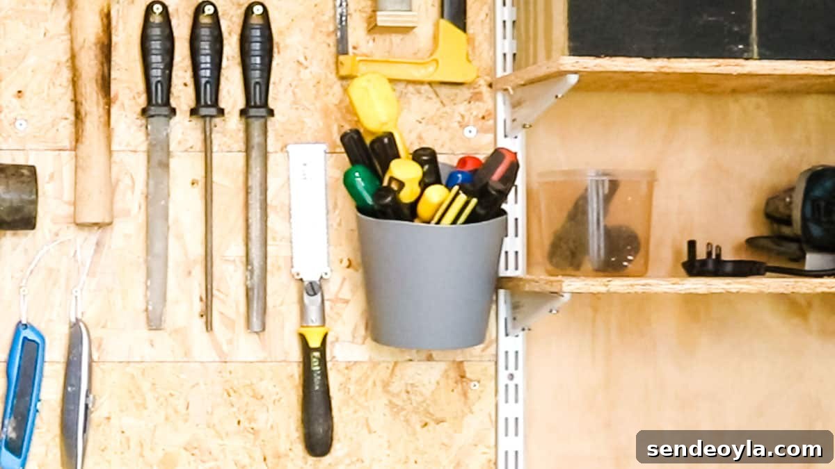 Quick DIY Wall-Mounted Tool Organizer for Garage 7 Pots full of screwdrivers screwed to a DIY tool wall
