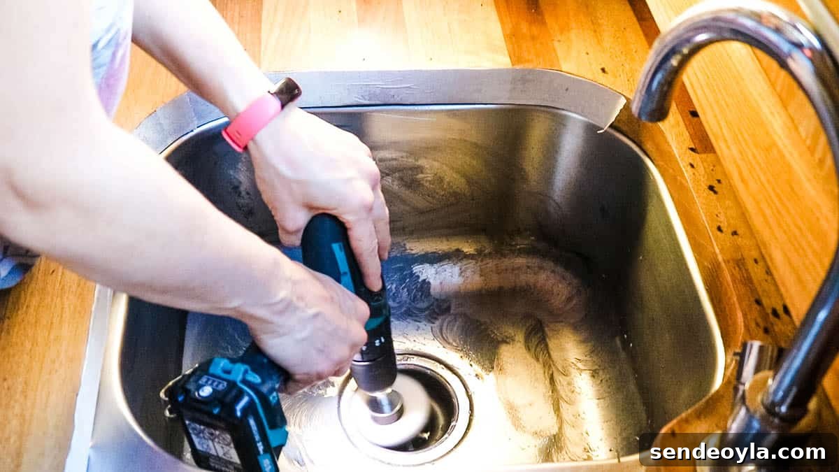 How to Remove Scratches from Stainless Steel Sinks 6 Using a drill attachment and metal polish to buff a sink drain