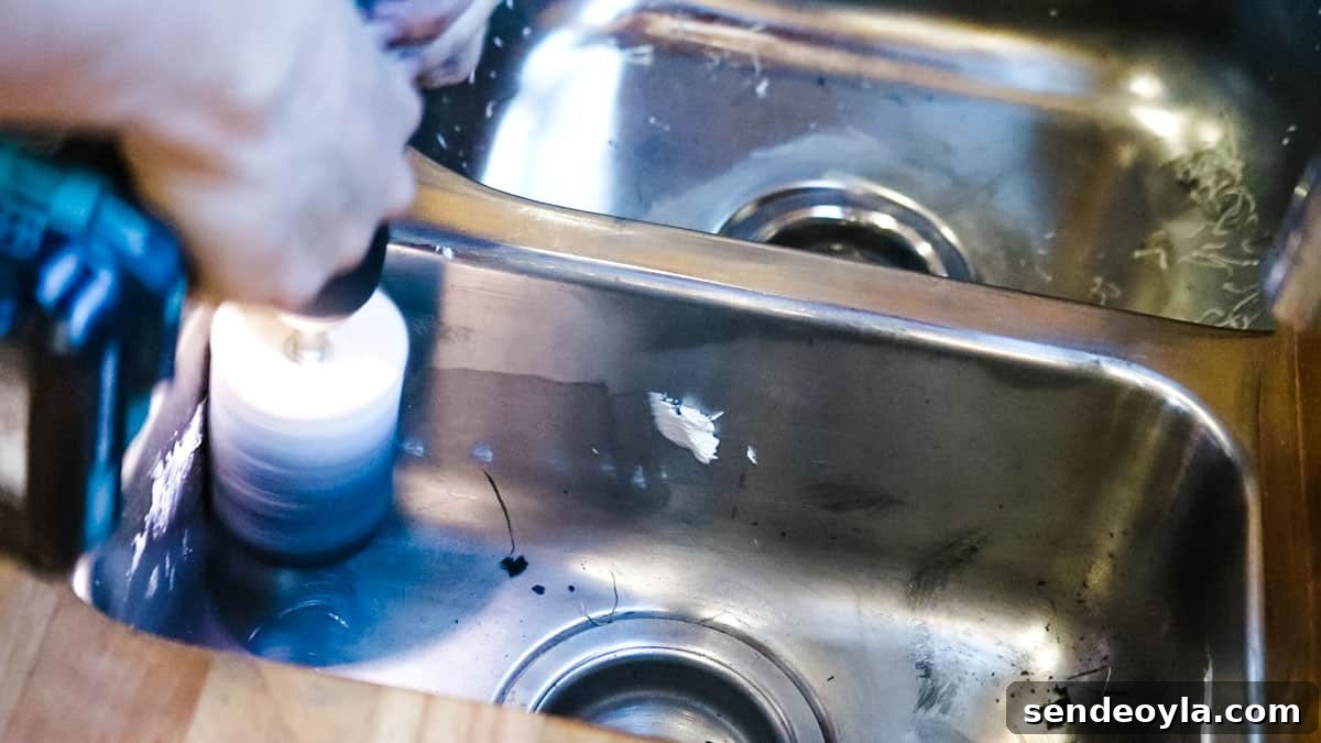 How to Remove Scratches from Stainless Steel Sinks 7 Using a drill attachment with polishing pad in the corner of a half rinse sink