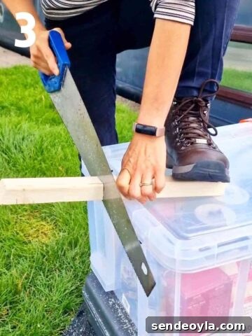 person hand sawing timber for a narrowboat small greenhouse