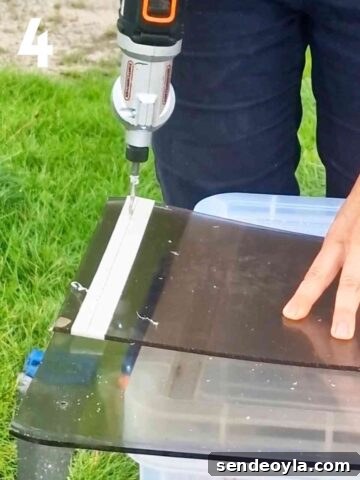 person drilling pilot holes through the front and back panel at the same time