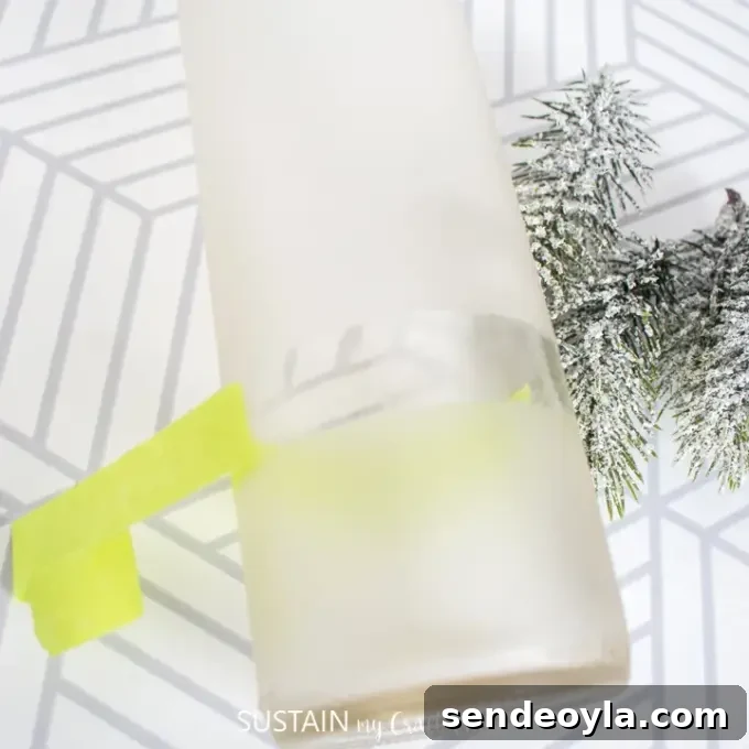 DIY Wine Bottle Holiday Centerpieces 8 Peeling tape from painted bottle
