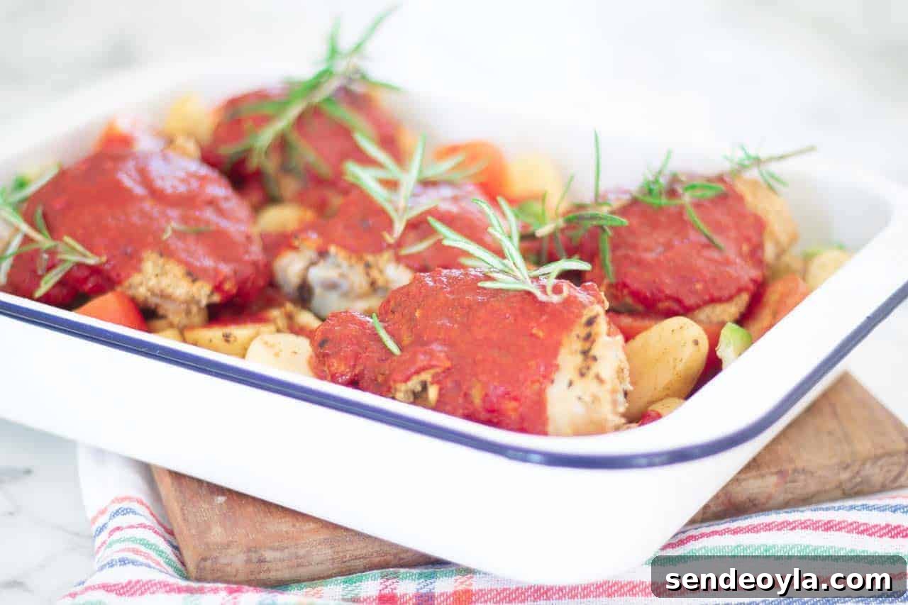 coated chillied chicken topped with tomato sauce and fresh rosemary