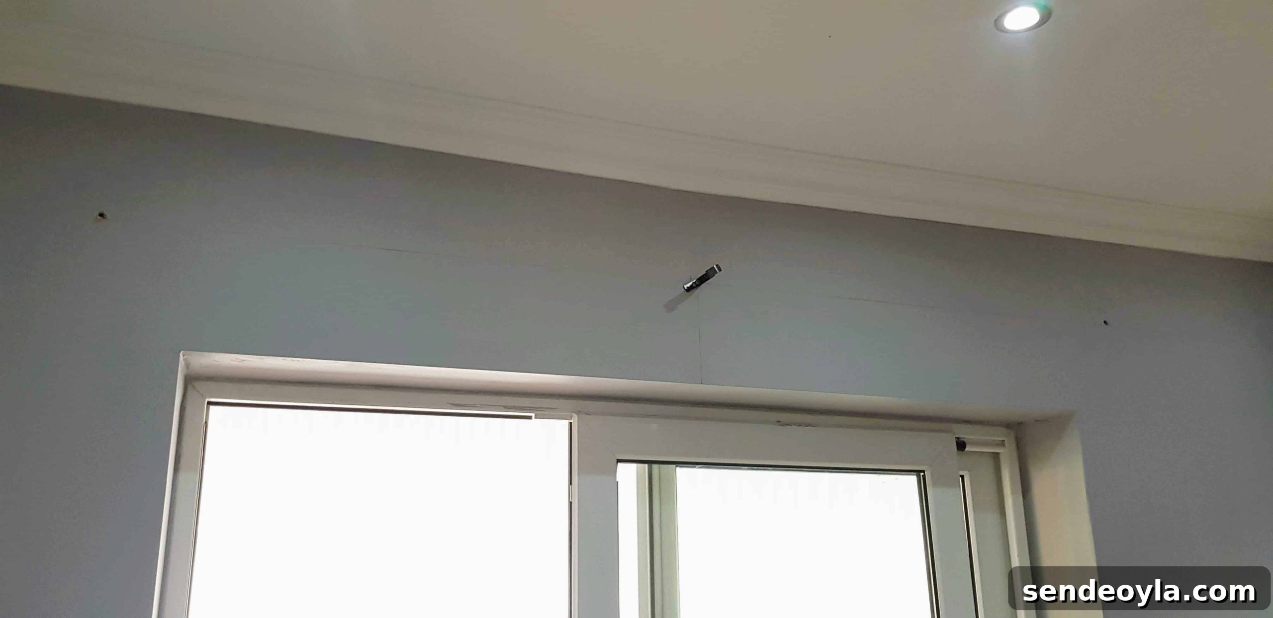 How to Install a Curtain Pole Batten with Grab Adhesive 3 Hitting a lintel, ending work.
