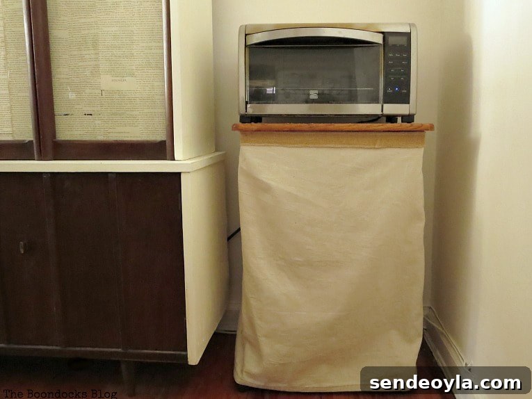 DIY Airtight Dog Food Storage Container 11 Cart with microwave covered in fabric.