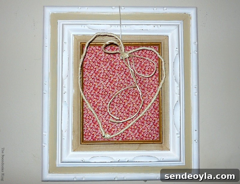 15 DIY Upcycle Ideas for Old Clothes 6 Frame decorated with a wire heart and repurposed old clothes.