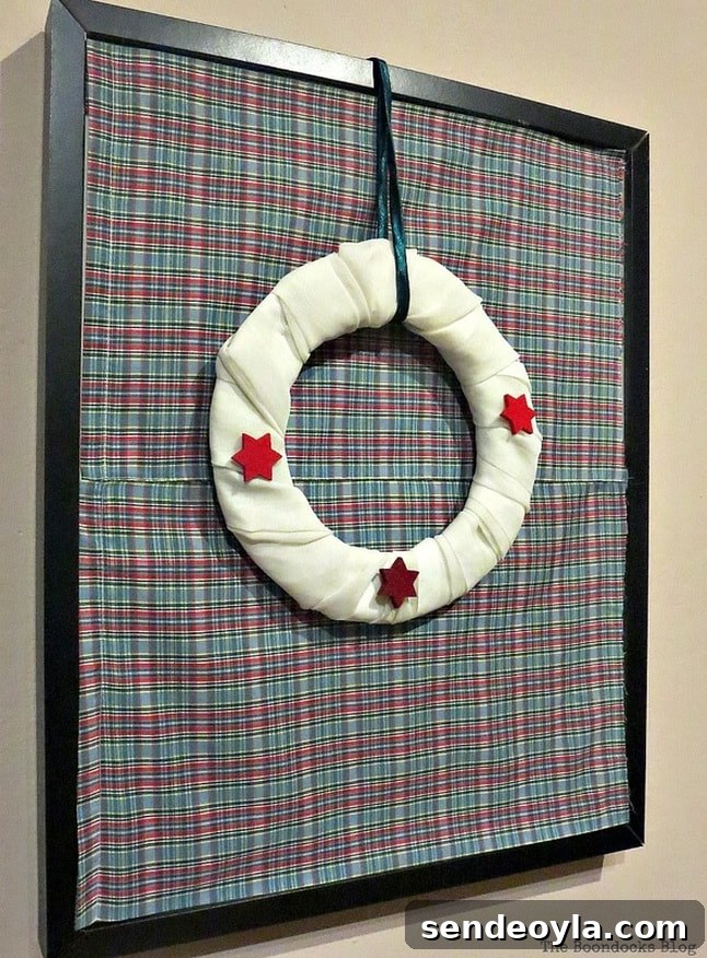 15 DIY Upcycle Ideas for Old Clothes 7 Christmas wreath hanging from a picture frame.