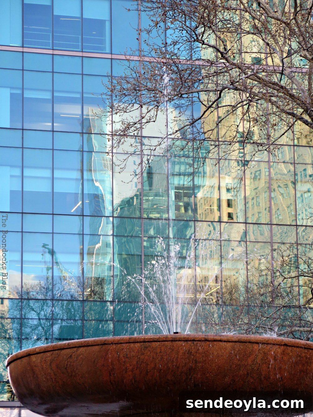 Discover Restored Bryant Park and Nearby Attractions 14 Reflections on Glass facade of skyscraper and the water fountain at the forefront, Bryant Park New York, A Visit to the Restored Bryant Park and its Surrounding Areas www.theboondocksblog.com