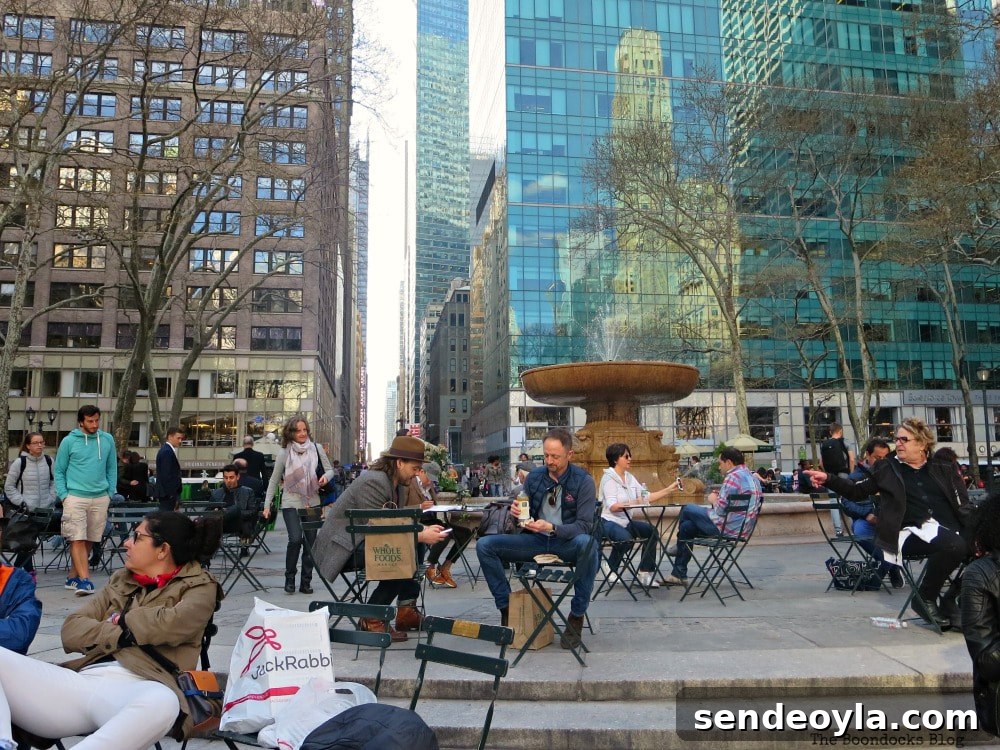 Discover Restored Bryant Park and Nearby Attractions 15 Memorial Fountain surrounded by people and movable chairs, on the west side of Bryant Park, New York, A Visit to the Restored Bryant Park and its Surrounding Areas www.theboondocksblog.com