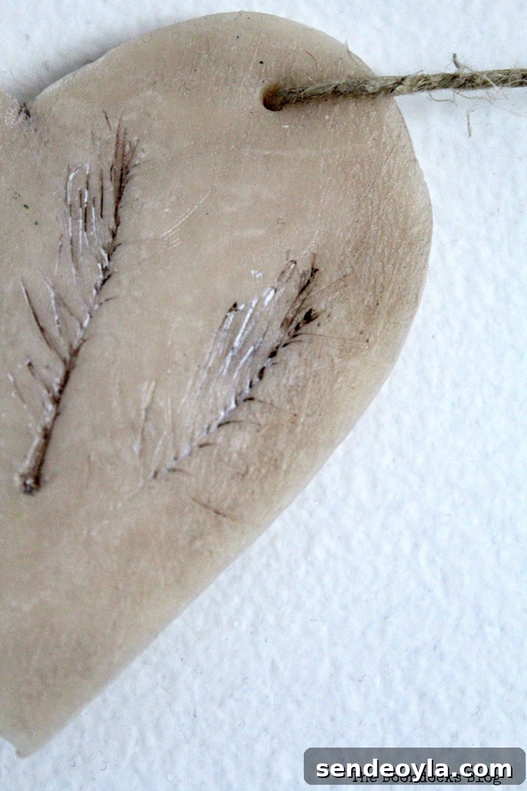 Close-up detail of pine branch indentations on clay heart