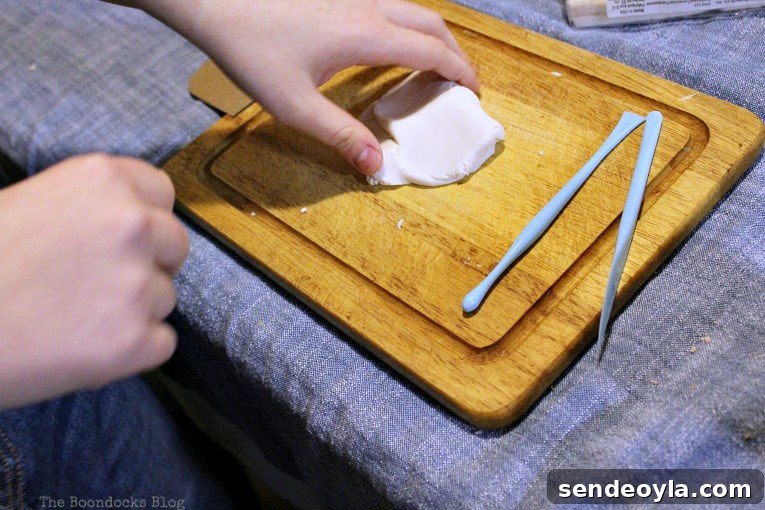Rolling out clay on a cutting board