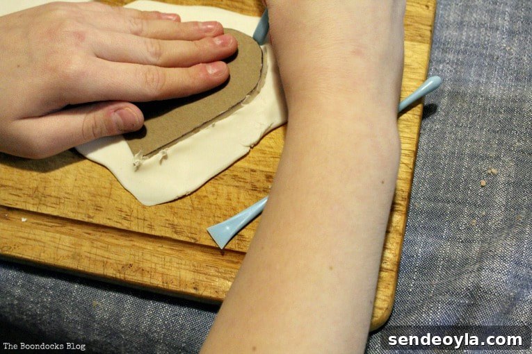 Cutting clay heart shape with a tool