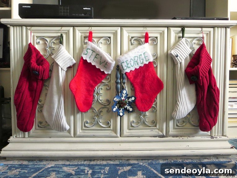How to Make Christmas Stockings from Old Sweaters 2 Red sweater Christmas stockings hanging on a white cabinet.