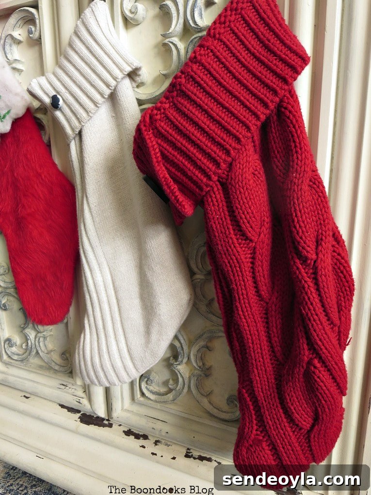 How to Make Christmas Stockings from Old Sweaters 12 Sweater stockings hanging on tv cabinet, repurposed sweaters Christmas stockings