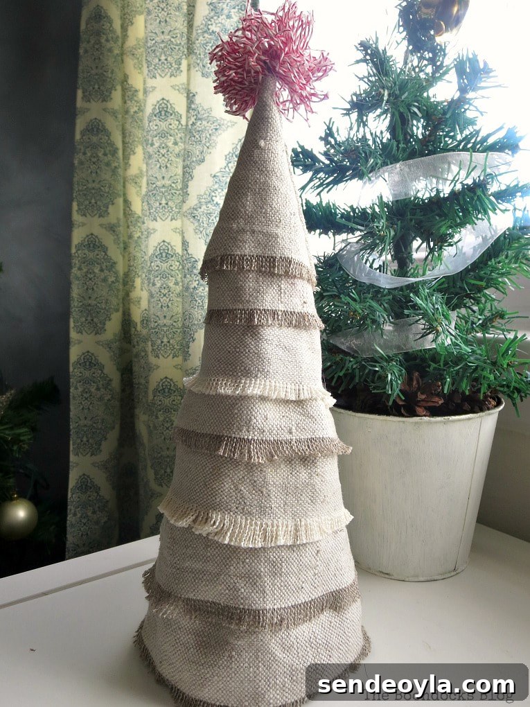 DIY Mini Christmas Tree from Dollar Store Fabric 12 Mini Christmas tree made with fabric scraps, placed in front of a mini potted evergreen tree.