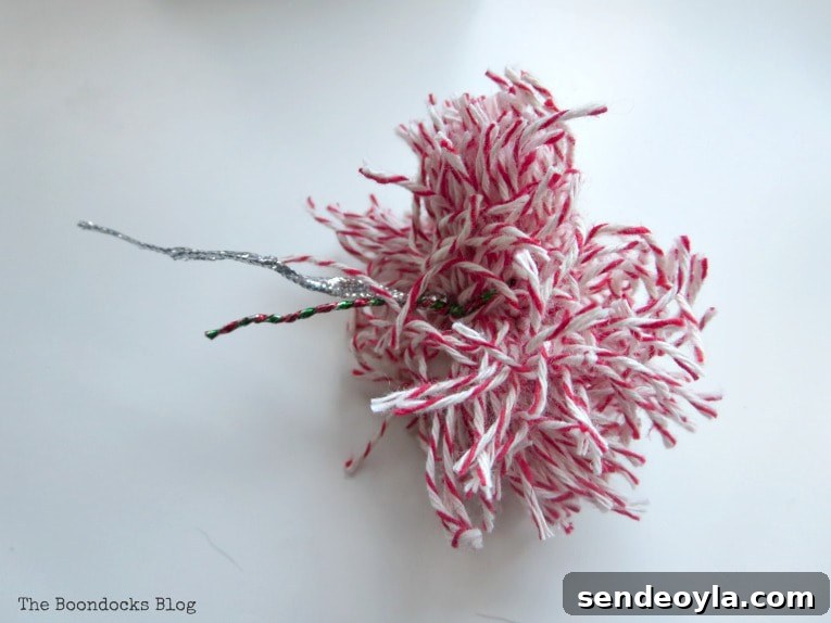 DIY Mini Christmas Tree from Dollar Store Fabric 8 Pompom made with red and white bakers twine.