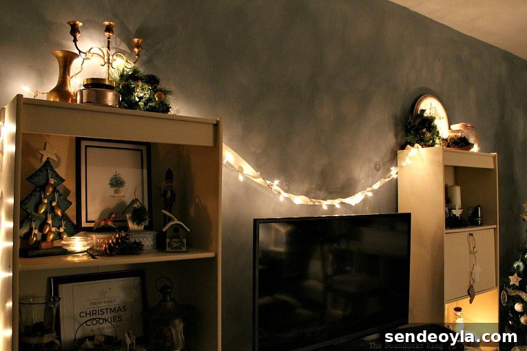 Upcycle Old Decor into Bright Christmas Vignettes 2 The bookcases in the living room all lit up, How to Reuse Old Decor to Make Bright Christmas Vignettes www.theboondocksblog.com