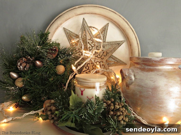 Upcycle Old Decor into Bright Christmas Vignettes 21 top of bookcase with star ornament, candle, ceramic pot and wreath, How to Reuse Old Decor to Make Bright Christmas Vignettes www.theboondocksblog.com