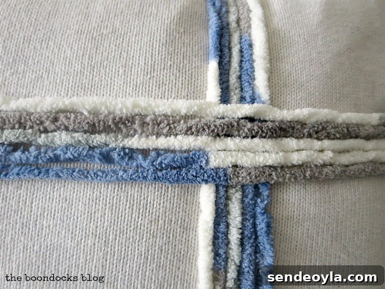 DIY Throw Pillows from Fabric Scraps: 5 Creative Ideas 11 close up of yarn on sweater pillow, How to Make Easy Pillows out of Fabric Remnants 5 ways www.theboondocksblog.com