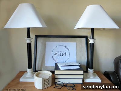 Turn a Lamp Base Into Faux Stone with Paint 19 Two repainted lamps beside books, a framed picture and reading glasses.