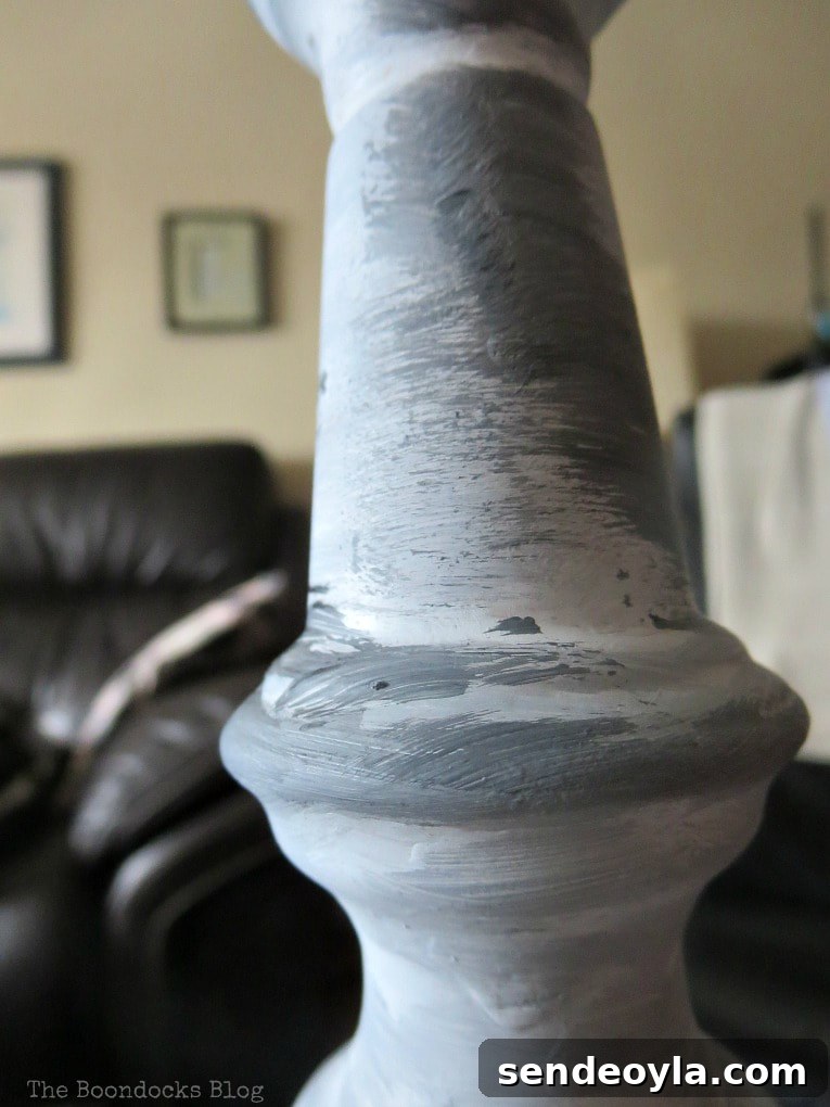 Turn a Lamp Base Into Faux Stone with Paint 5 Painting layers of grey to the lamp post.