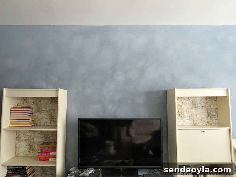 How to Paint a Cloud Accent Wall: DIY Step-by-Step Guide 15 Two shelves and a TV placed infront of an accent wall with cloudy effect.